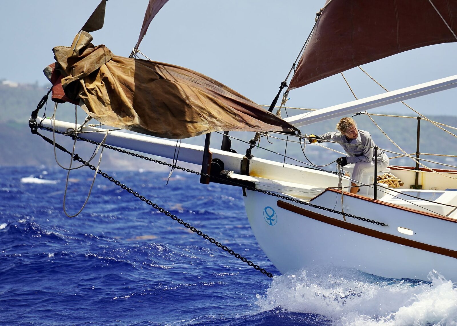 Cherub under full tan sail, the Venus mark on her topsail