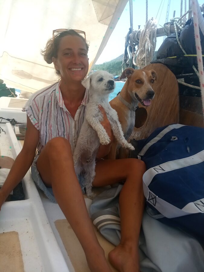 Angela aboard Cherub with two dogs